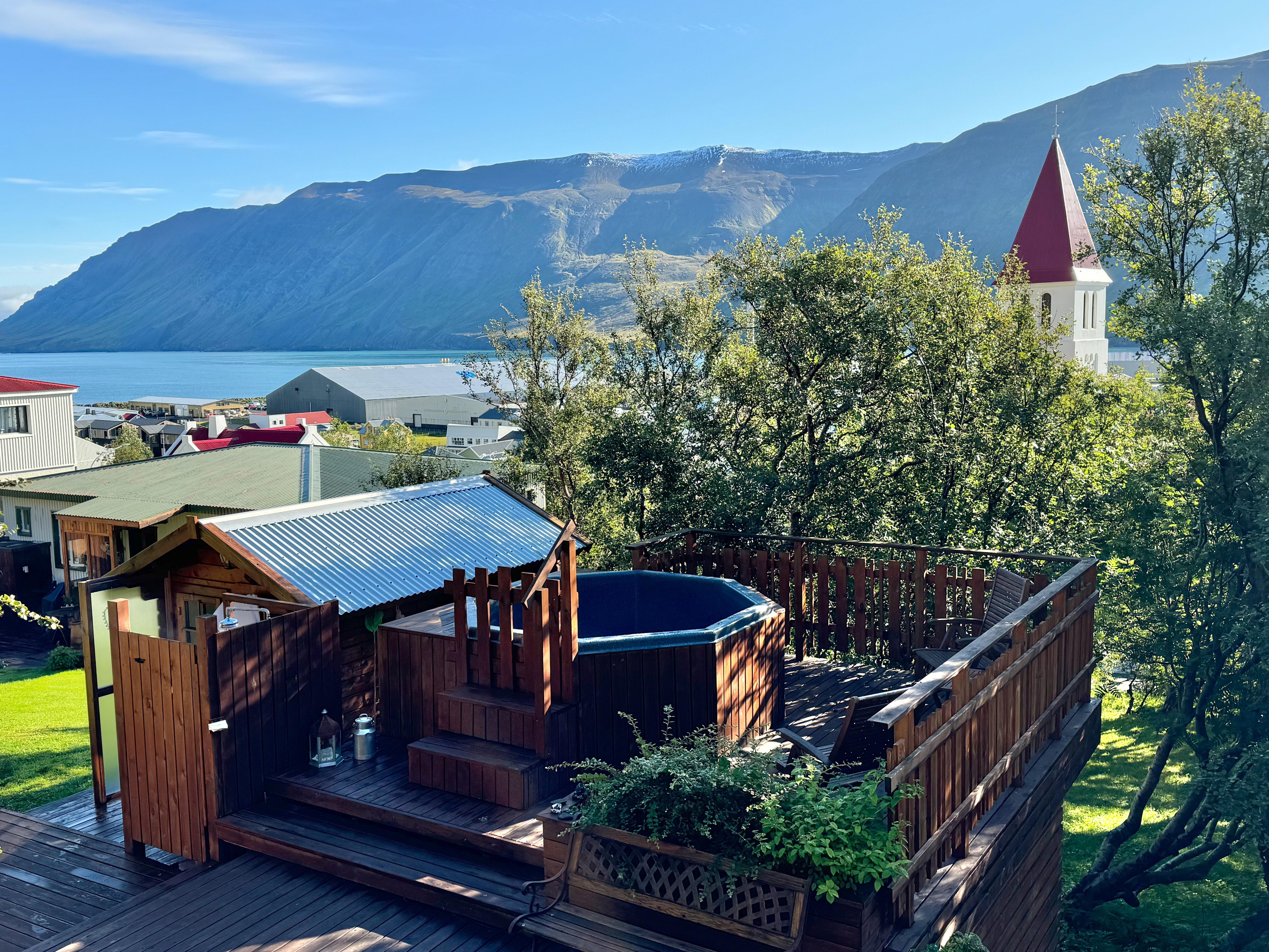 Hot tub and shower area with incredible fjord and church view