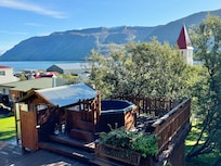 Hot tub and shower area with incredible fjord and church view