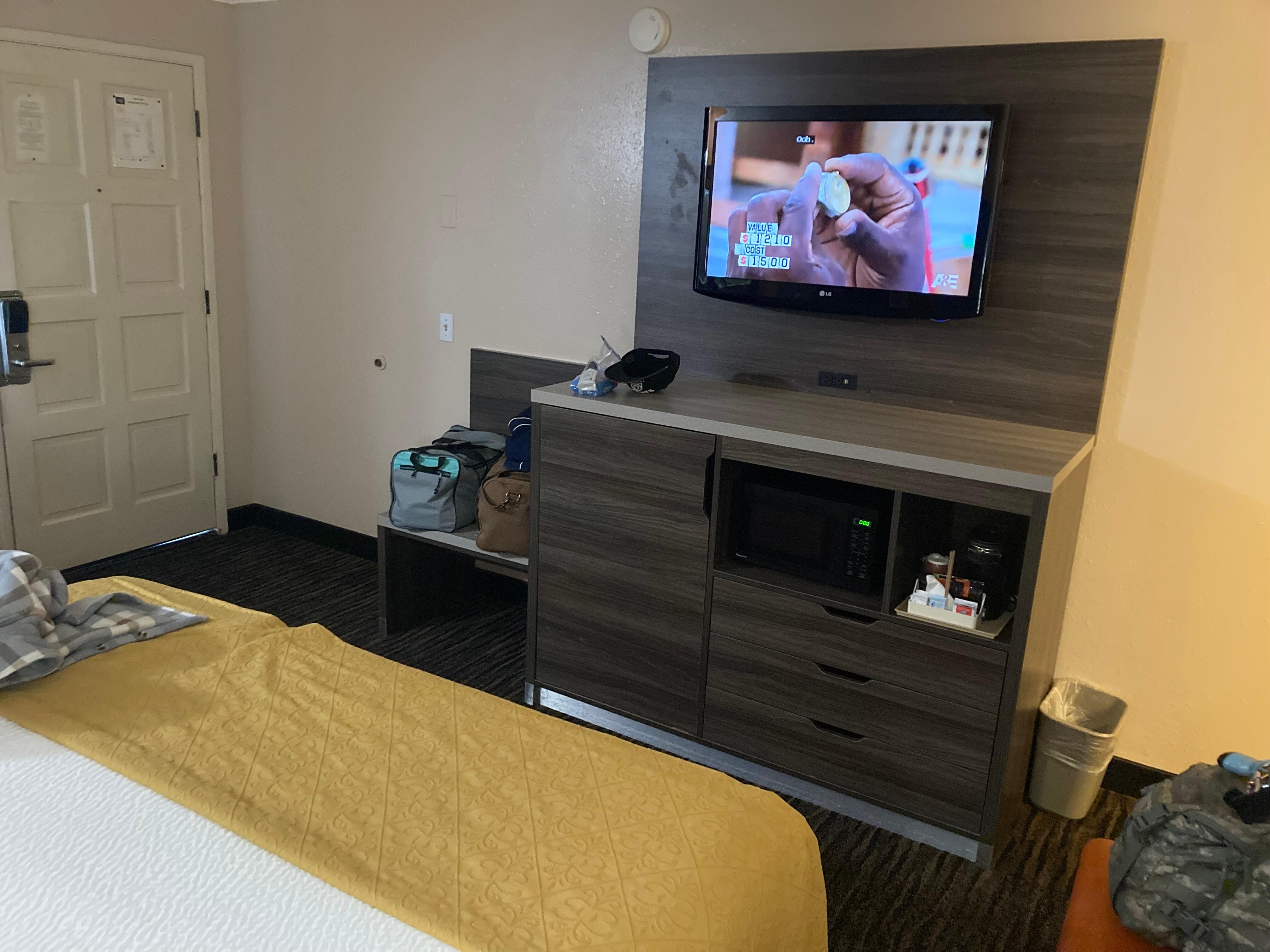 Tv and drawer with built in fridge and coffee machine.
