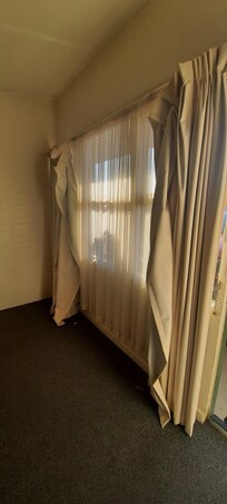 Curtains hanging off rail.