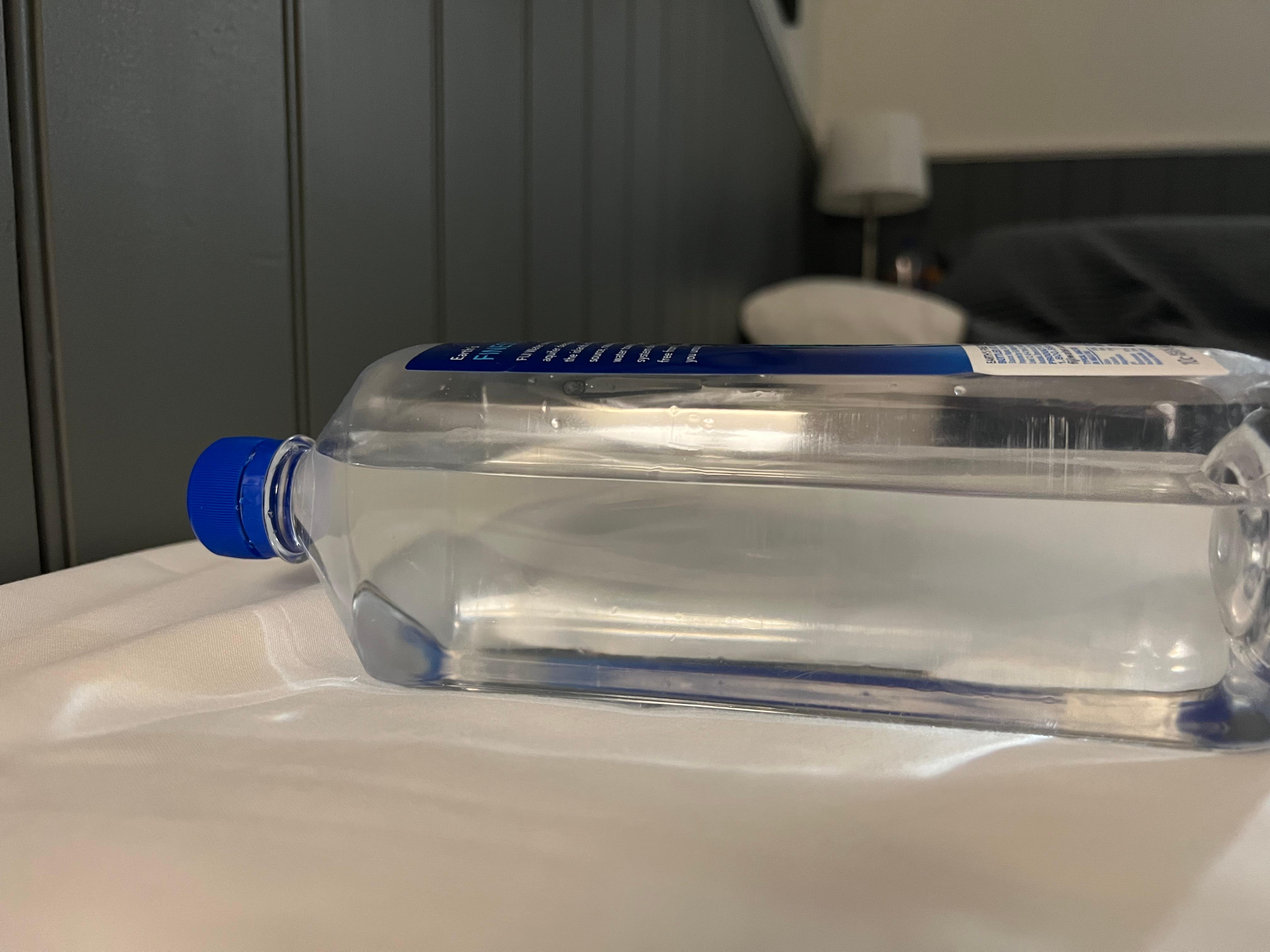 Water bottle to illustrate unevenness of bed
