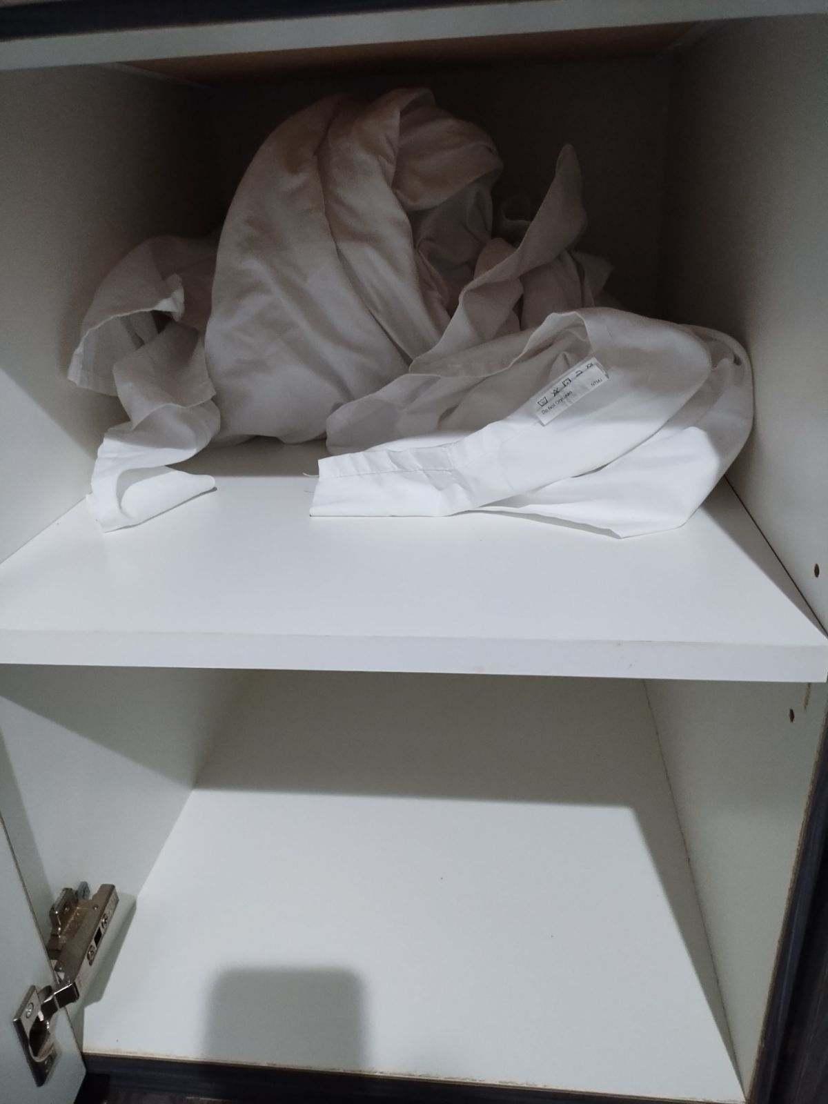 Used sheets bundled up under sink
