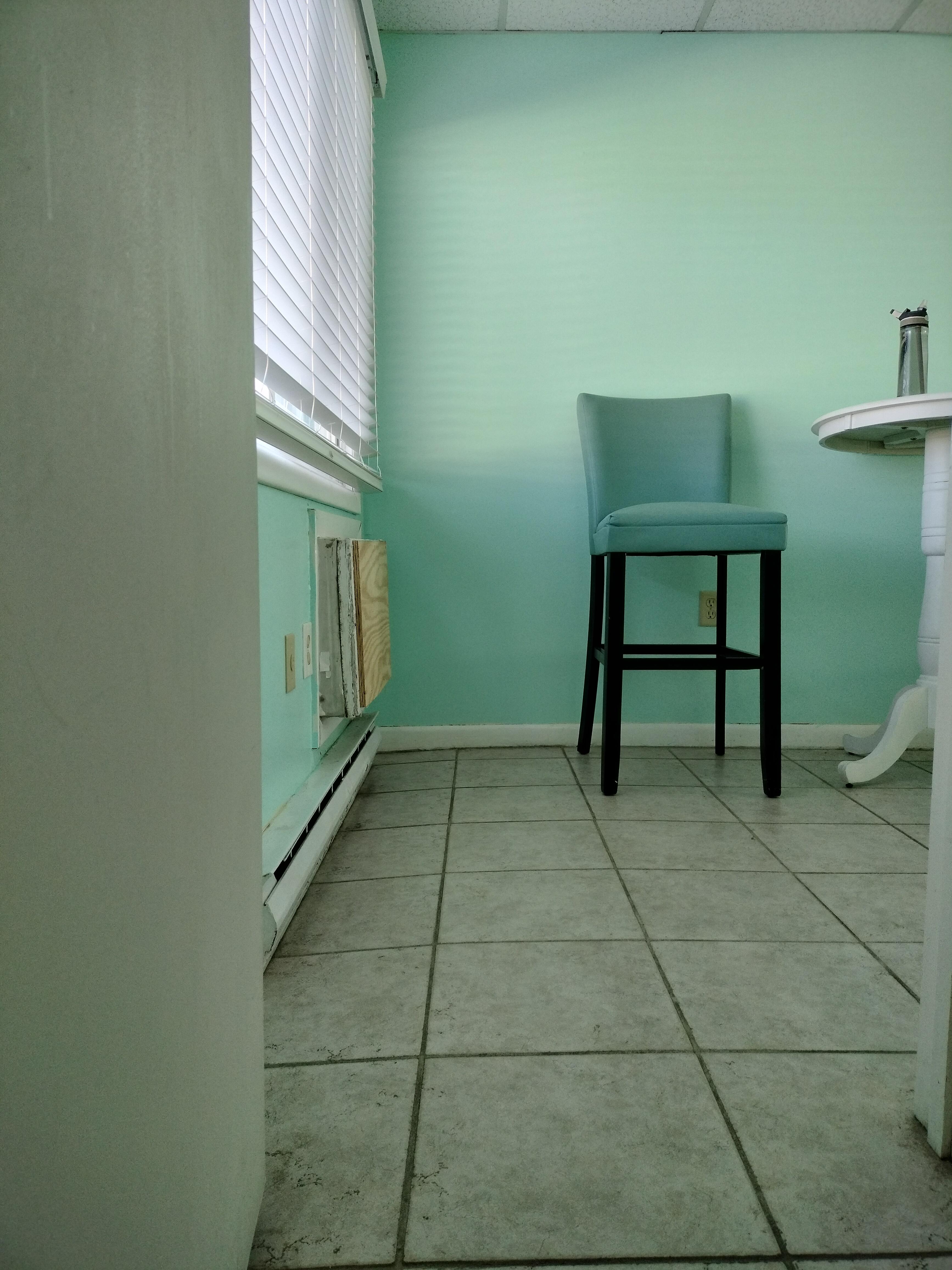 Floor slopes toward window.  The rungs on the chairs are broken.