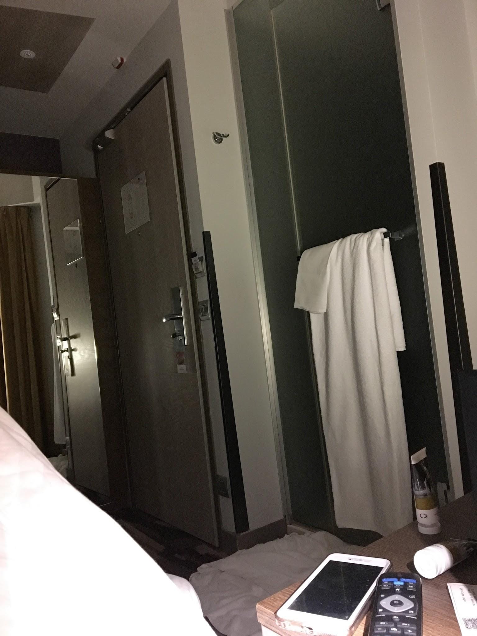 Shower outside the bathroom near door and bed