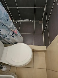 Less than a foot between the toilet and wall
