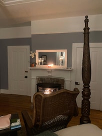 Somerset Suite Fireplace and door angle sitting on bed.