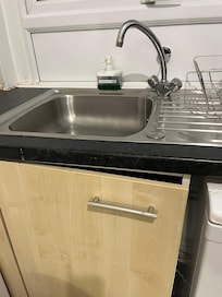 Broken cupboard and dirty sink
