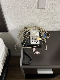 Phone with cord trailed around the room and plugged in nowhere