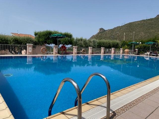 This is the pool. No-one swimming as the person under the umbrella tells them to get out if they dont have a 'bathing cap'.