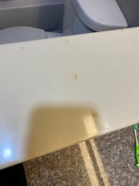 Cigarette burns on bathroom counter