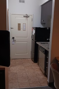 Odd to cram fridge into space that used to be the hallway closet.