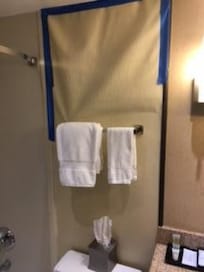 Hole in wall covered up by paper.