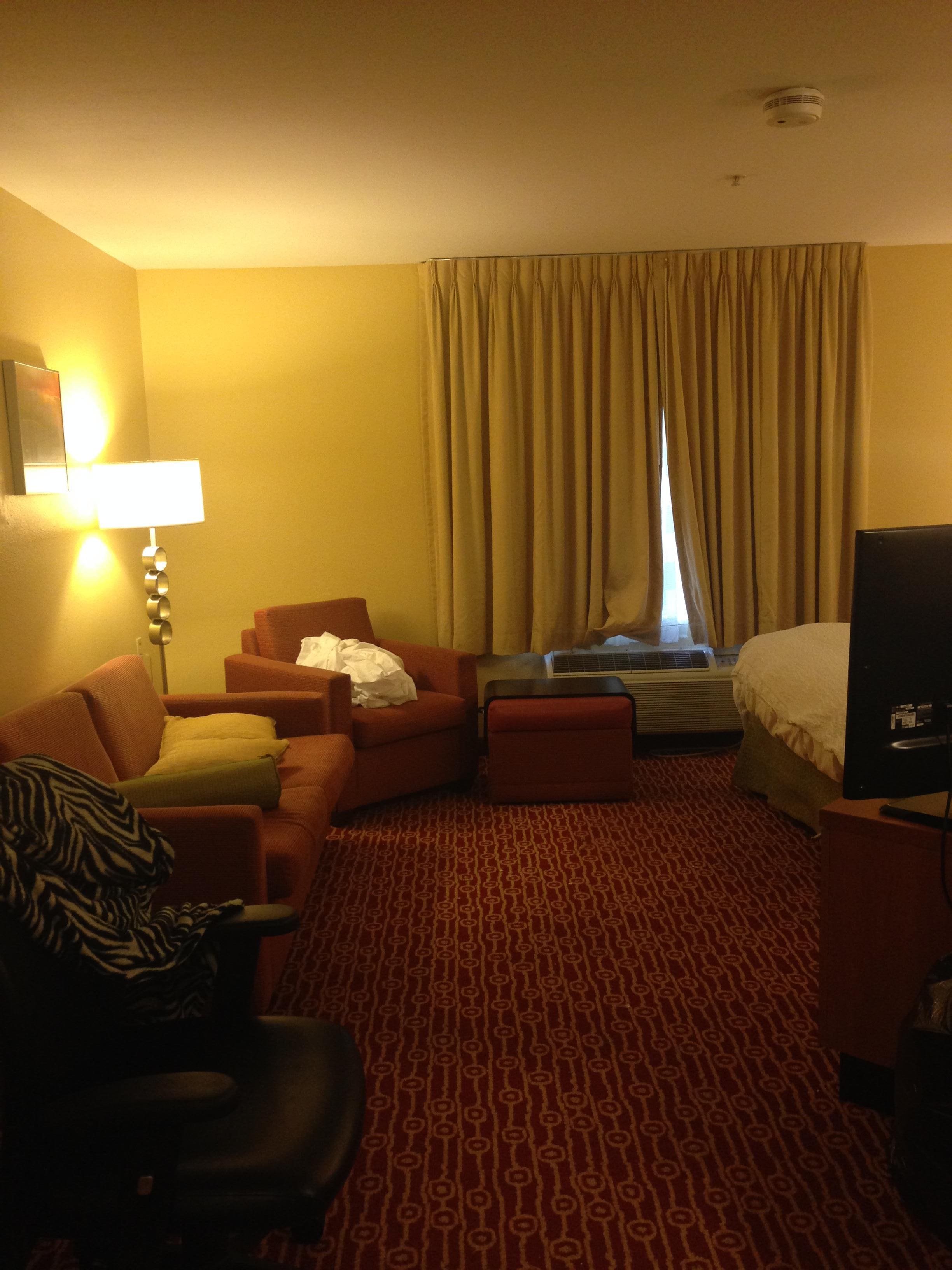 From the door facing in. Sofa is to the back left. Bed to the back right and kitchen on the side of bed.