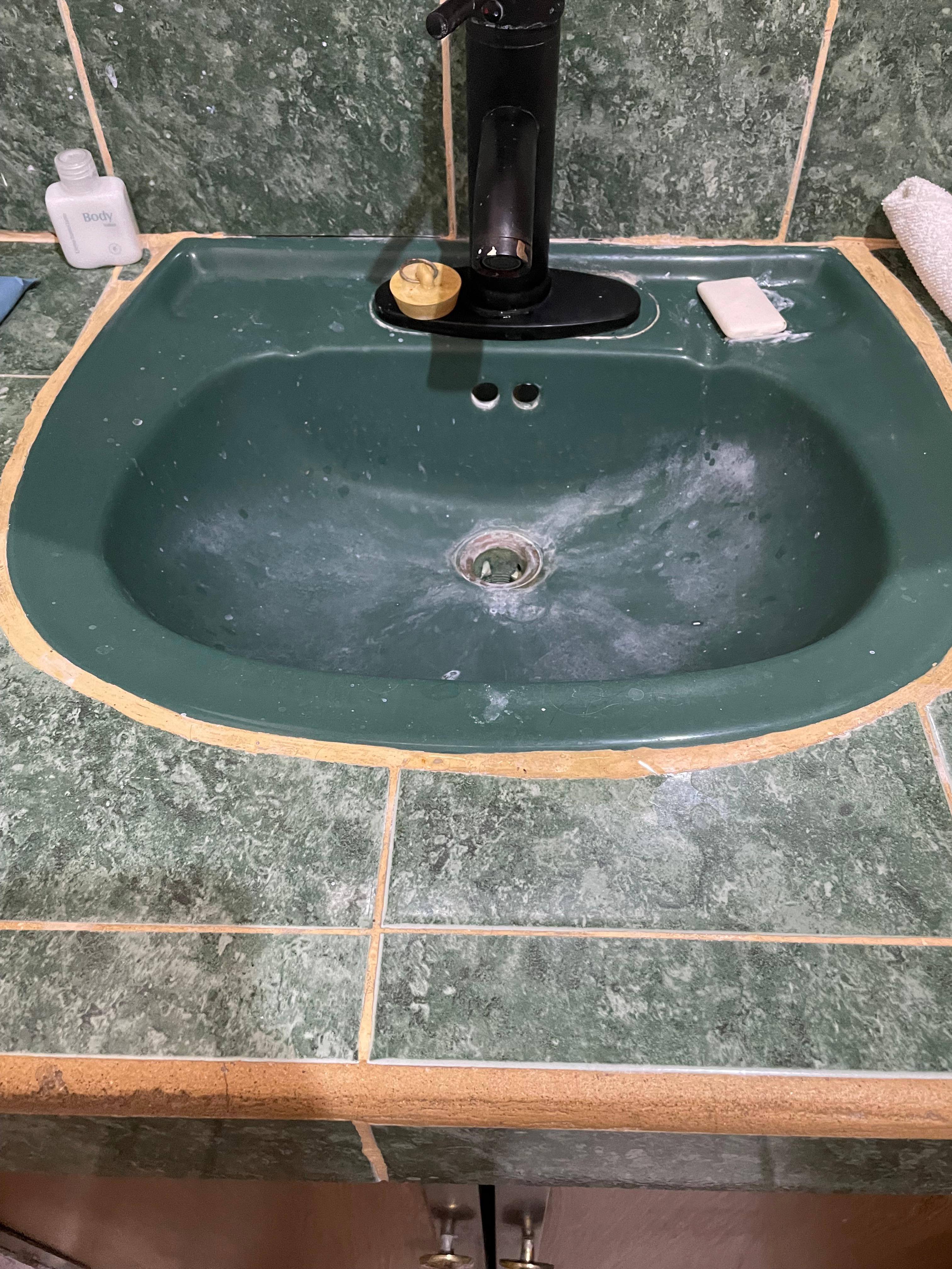 Corroded bathroom sink. No hot water