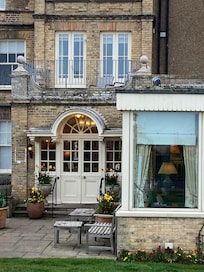 The main entrance with the balcony and room above