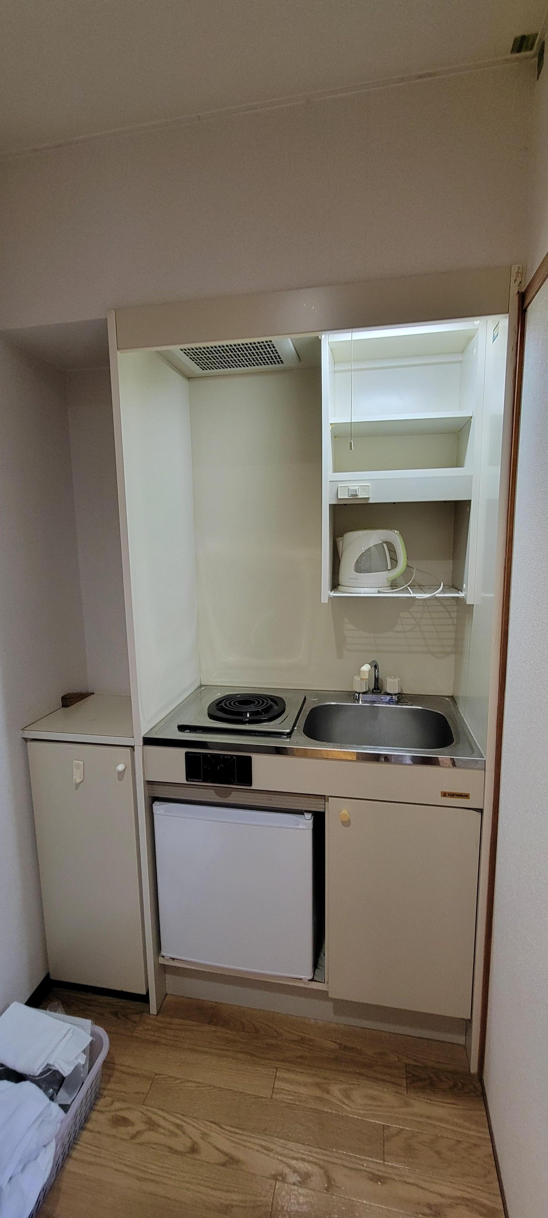 Small kitchen unit. Perfect if you want to cook (but I don't). Fridge for cold stuff. Entrance tight & you MUST remove your shoes.