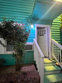 Adorable cottage. Roses. Pomegranites and blueberries and grape trees/vines. Lots of swings and seating in patios and 2 sweet resident cats.