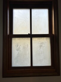 Dirty bathroom window (frosted for privacy, but still dirty). Bright light shining directly into room all night.