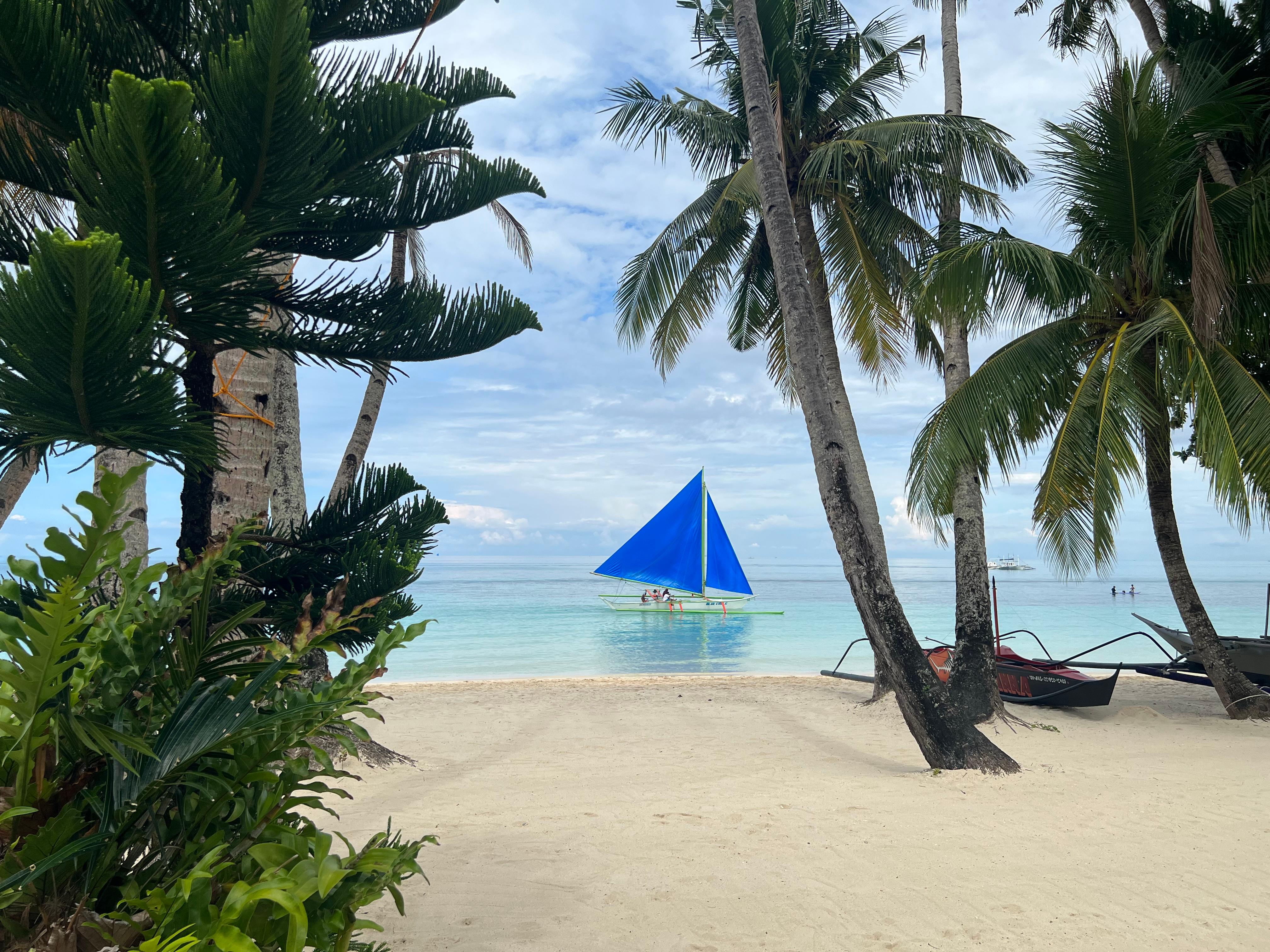 Sailing boat going by immediately in front of Boracay Beach houses. Not a soul around. The photo doesn’t look real but it is. 