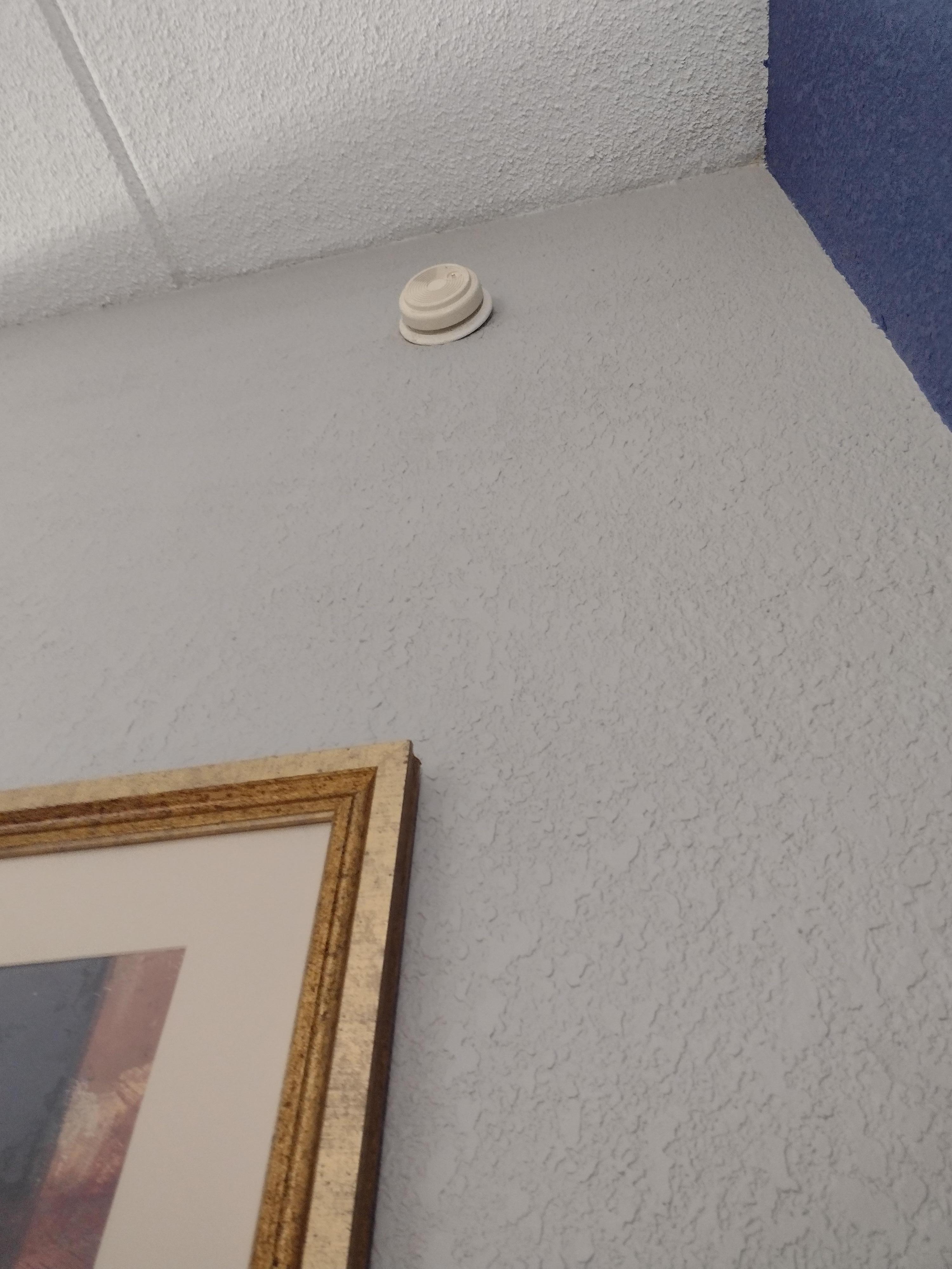Room smoke detector hanging half way off wall and not working as light was red.