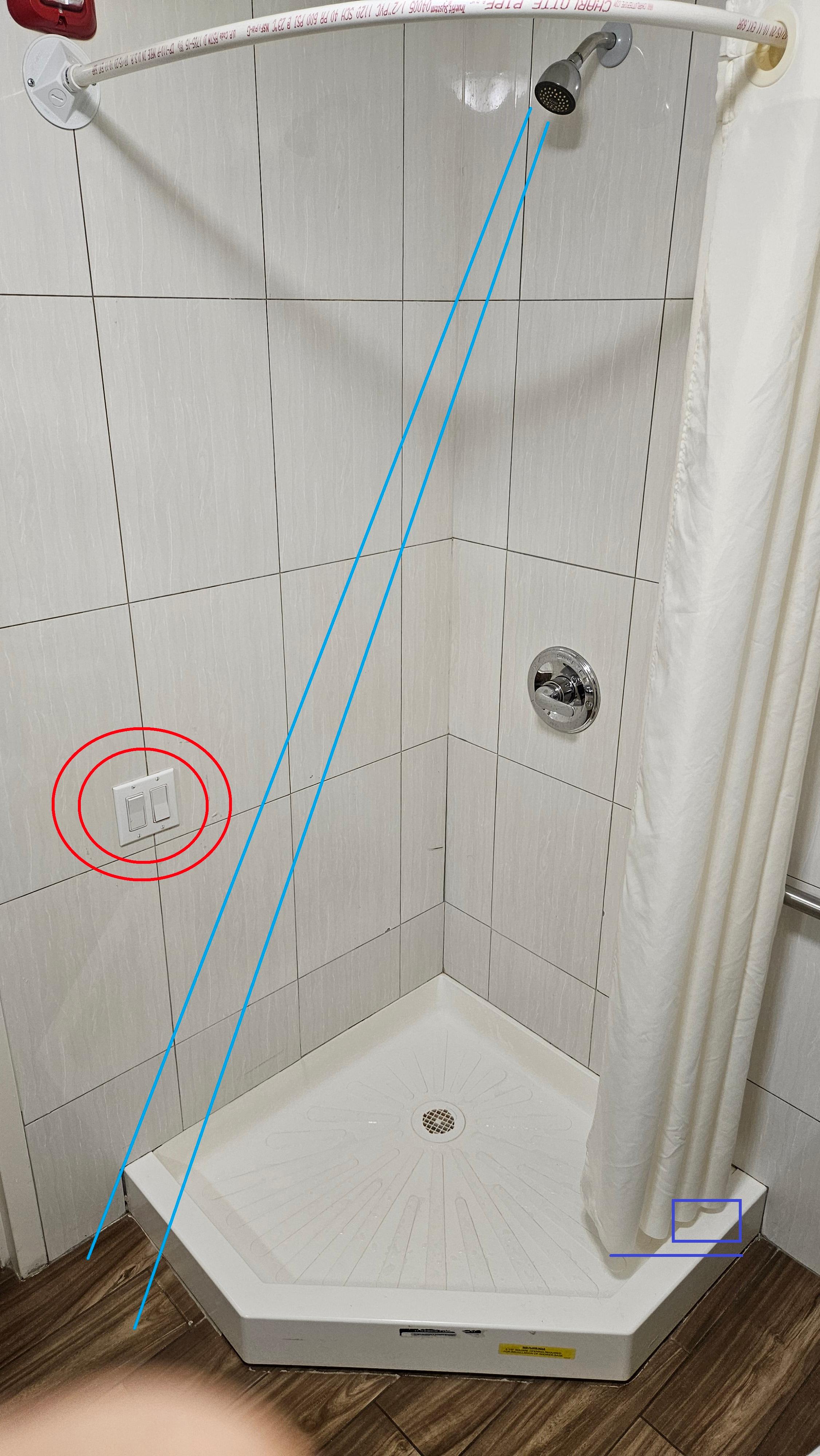 Unsafe and poorly designed shower set up.
Shower curtain too short to keep water inside the pan.  And electrical switches are inside the shower and they do get wet !!