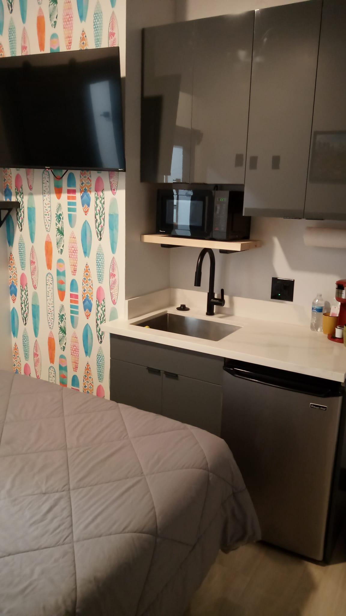 Picture of kitchen area with TV.
