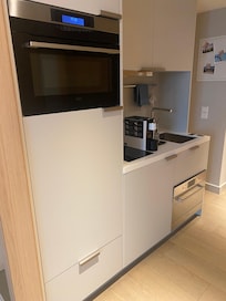 Kök med diskmaskin, ugn & mikro, kyl & frys, spis och tvättmaskin.