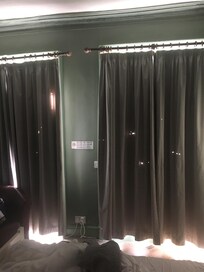 Moth eaten curtains and dirty windows