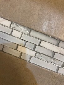 Broken glass tiles in the shower