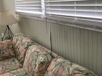 Dirty couch and buckling wall due to water damage