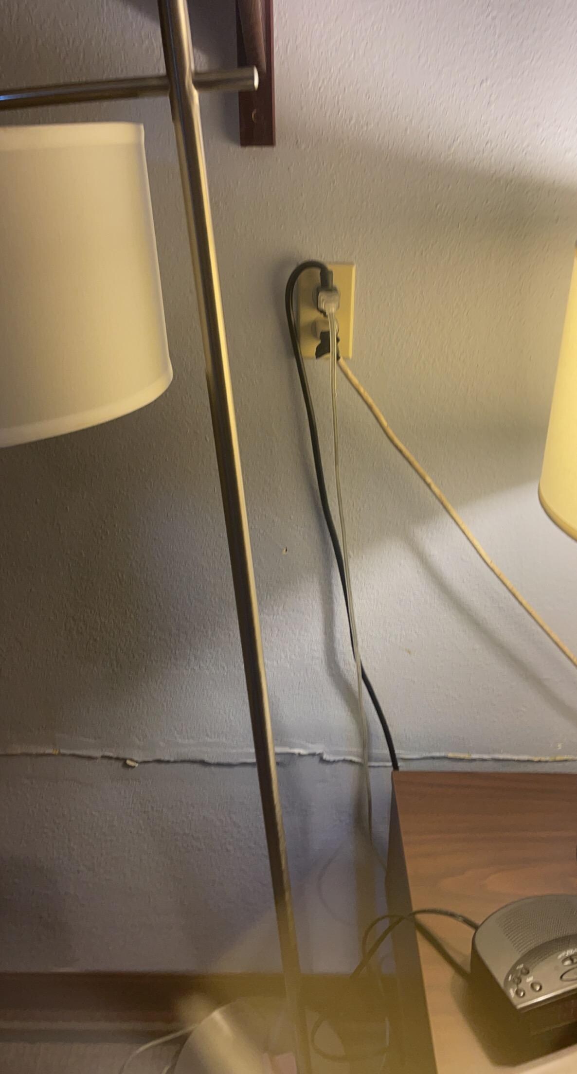 This was the outlet that had 2 power strips connected to it. The lamp next to it was broken just sitting in the room for storage. 