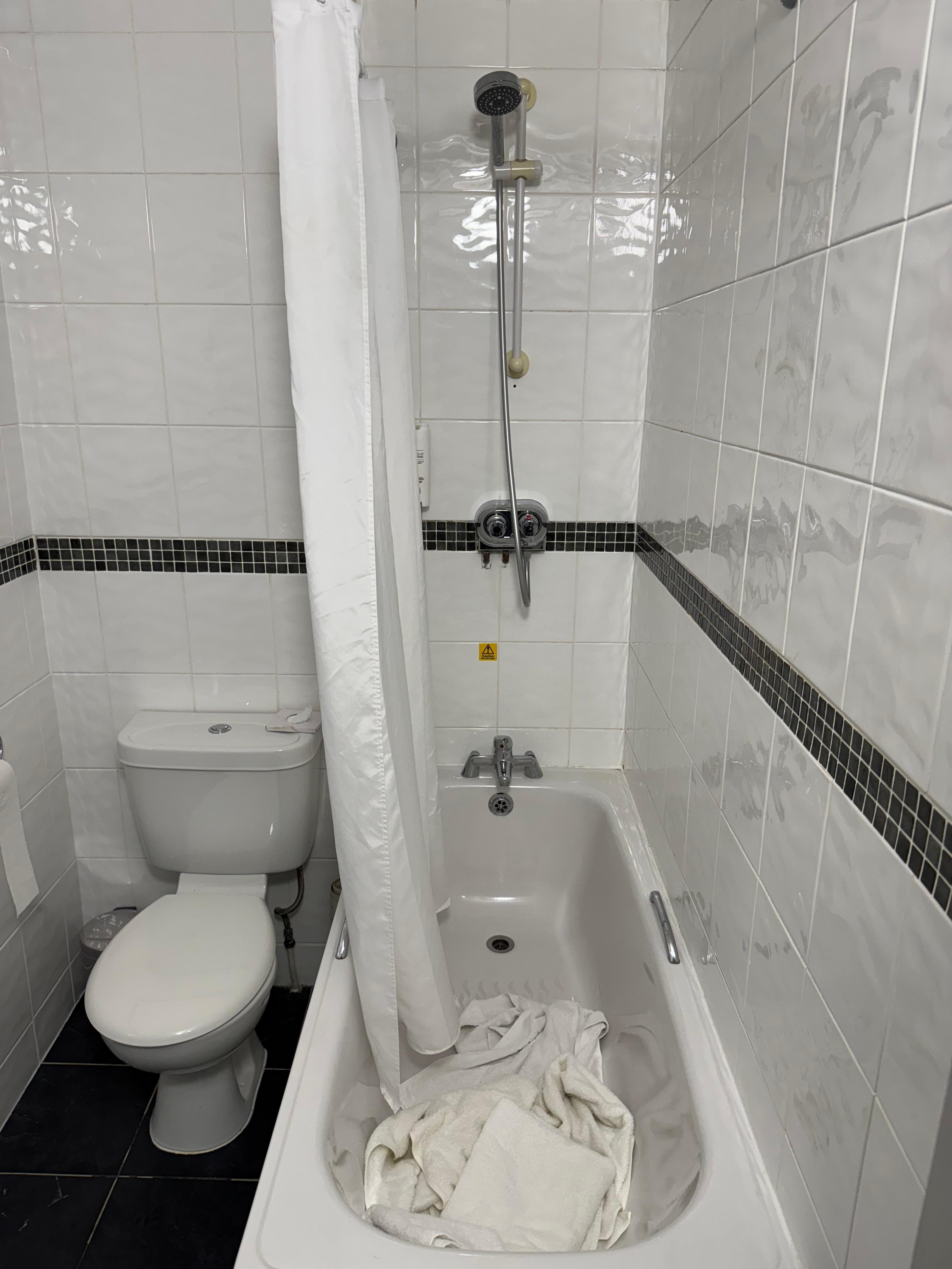 The mixer shower that you are expected to climb into a bath to get to… in 2025.