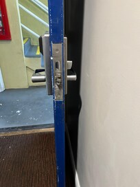The door which had the wrong metal piece over the latch and lock.
