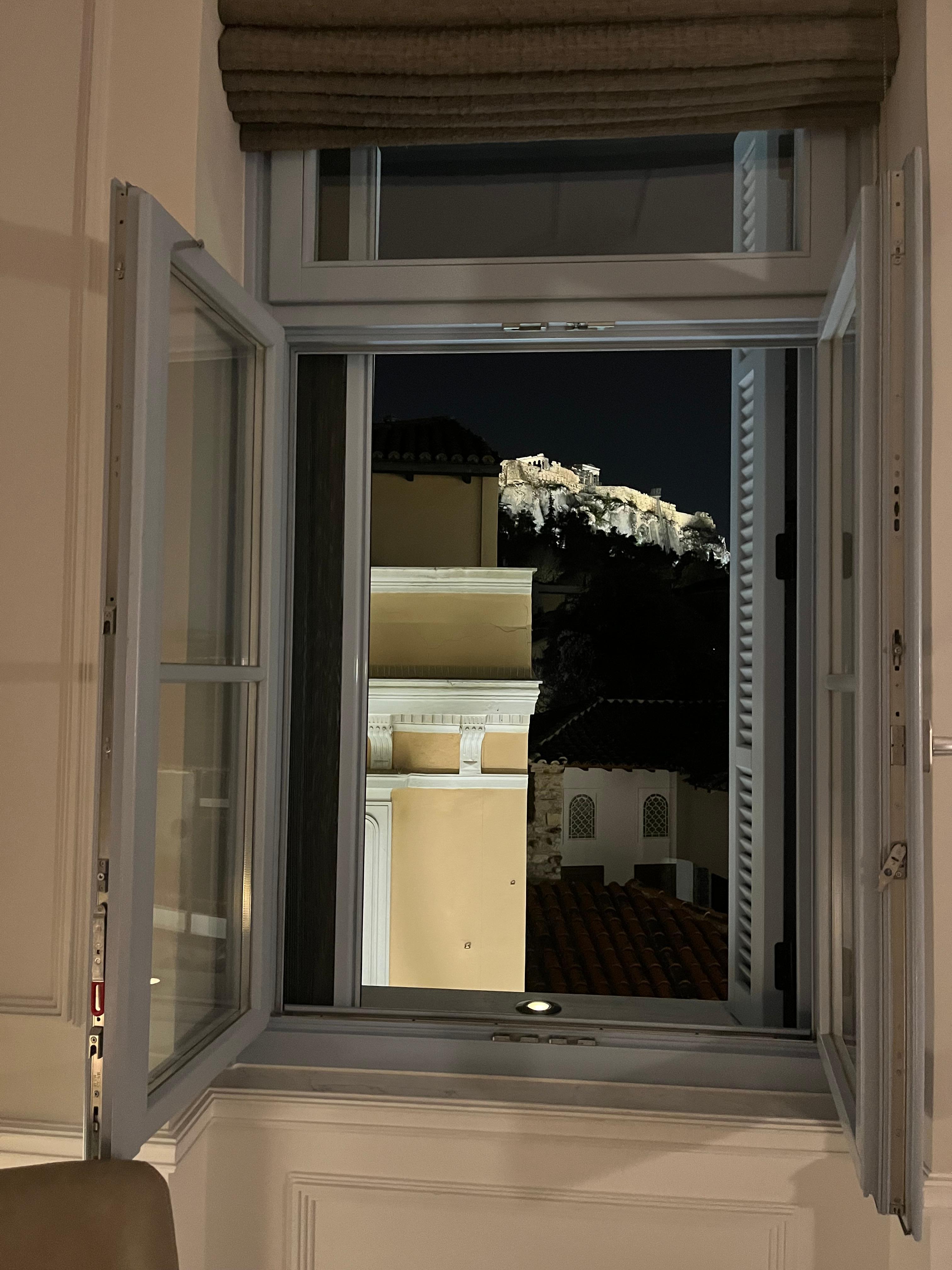 View of the acropolis through the shutters at night