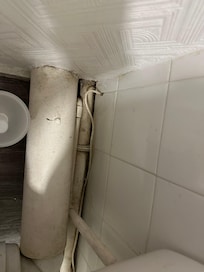 Dirt round exposed pipes