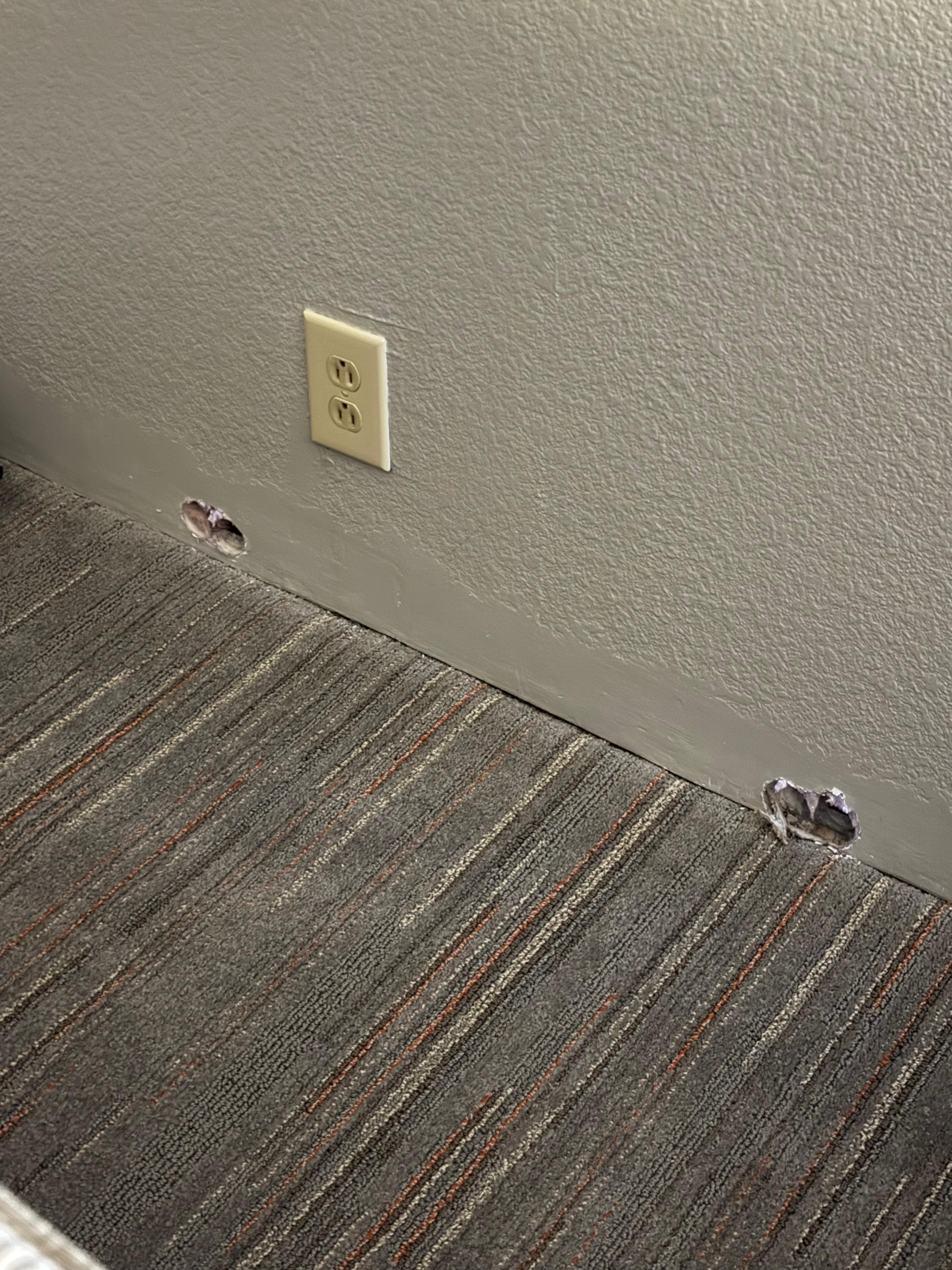 Holes left in the wall from moving a/c unit during remodel, but weren’t patched. 