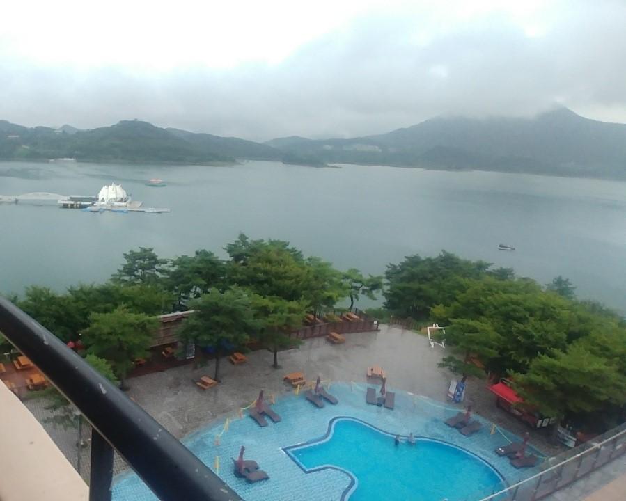 View from room balcony of lake and hotel pool.