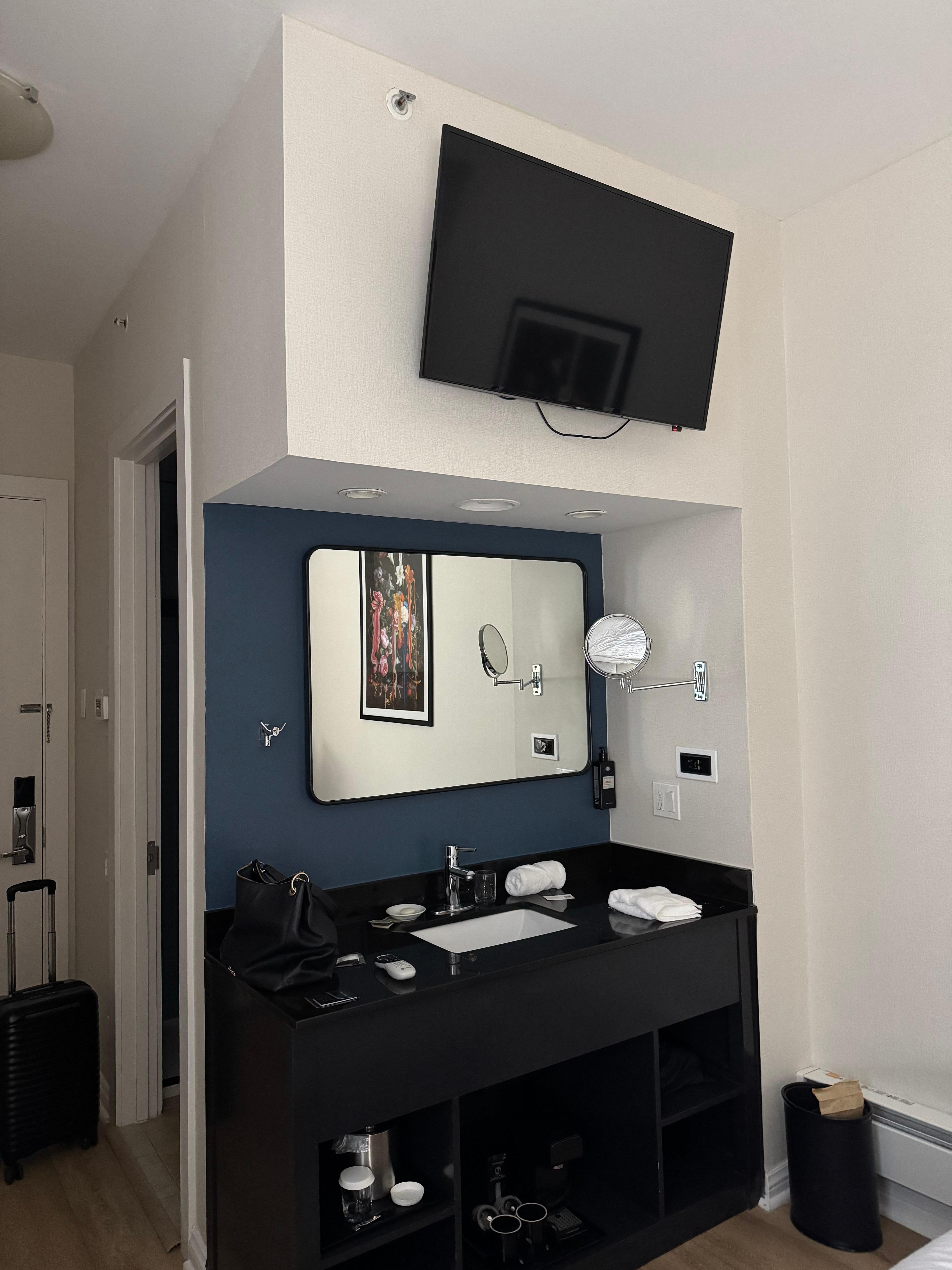 Sink in room with tv above