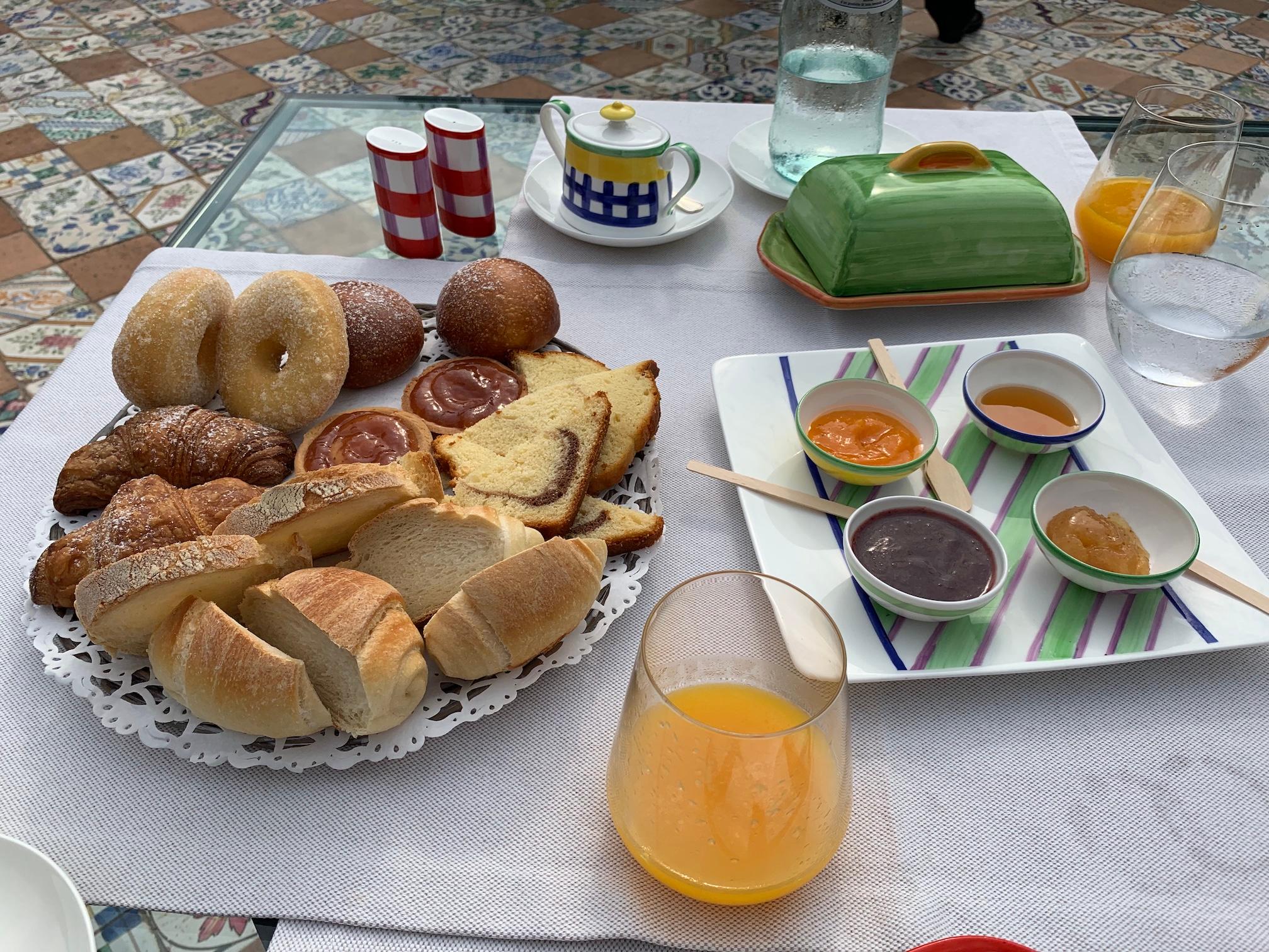 Breakfast pastries, and orange juice +  homemade jams/honey from their farm grown fruits