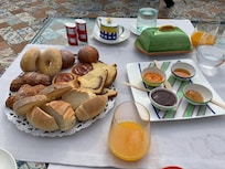 Breakfast pastries, and orange juice + homemade jams/honey from their farm grown fruits