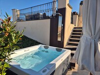 Shared rooftop terrace with hot tubs