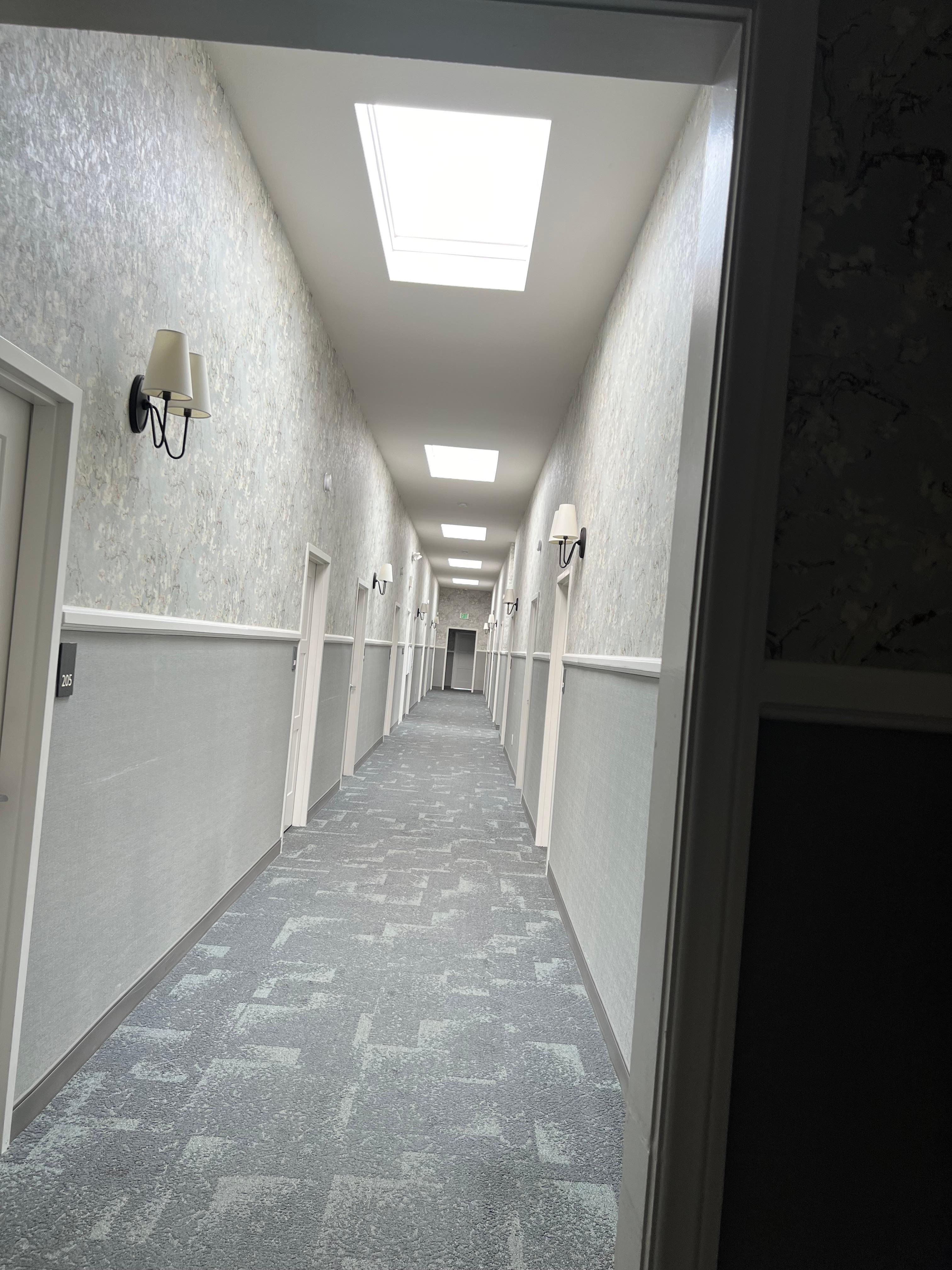 Hallways with lots of skylights giving nice bright feel