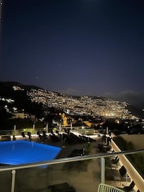 Outdoor pool and view from the breakfast room over Funchal