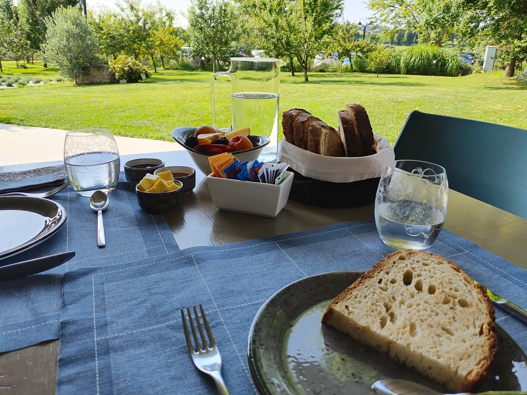 Breakfast on the patio with bread and fruit and capuccino