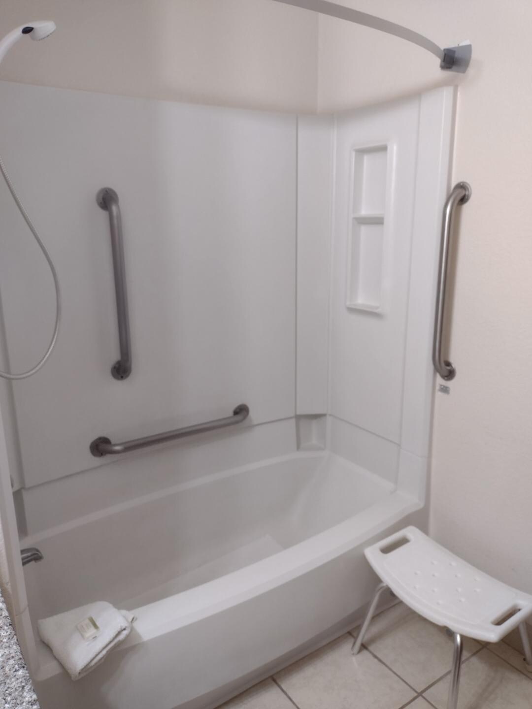 un-useable shower chair, no shower curtain