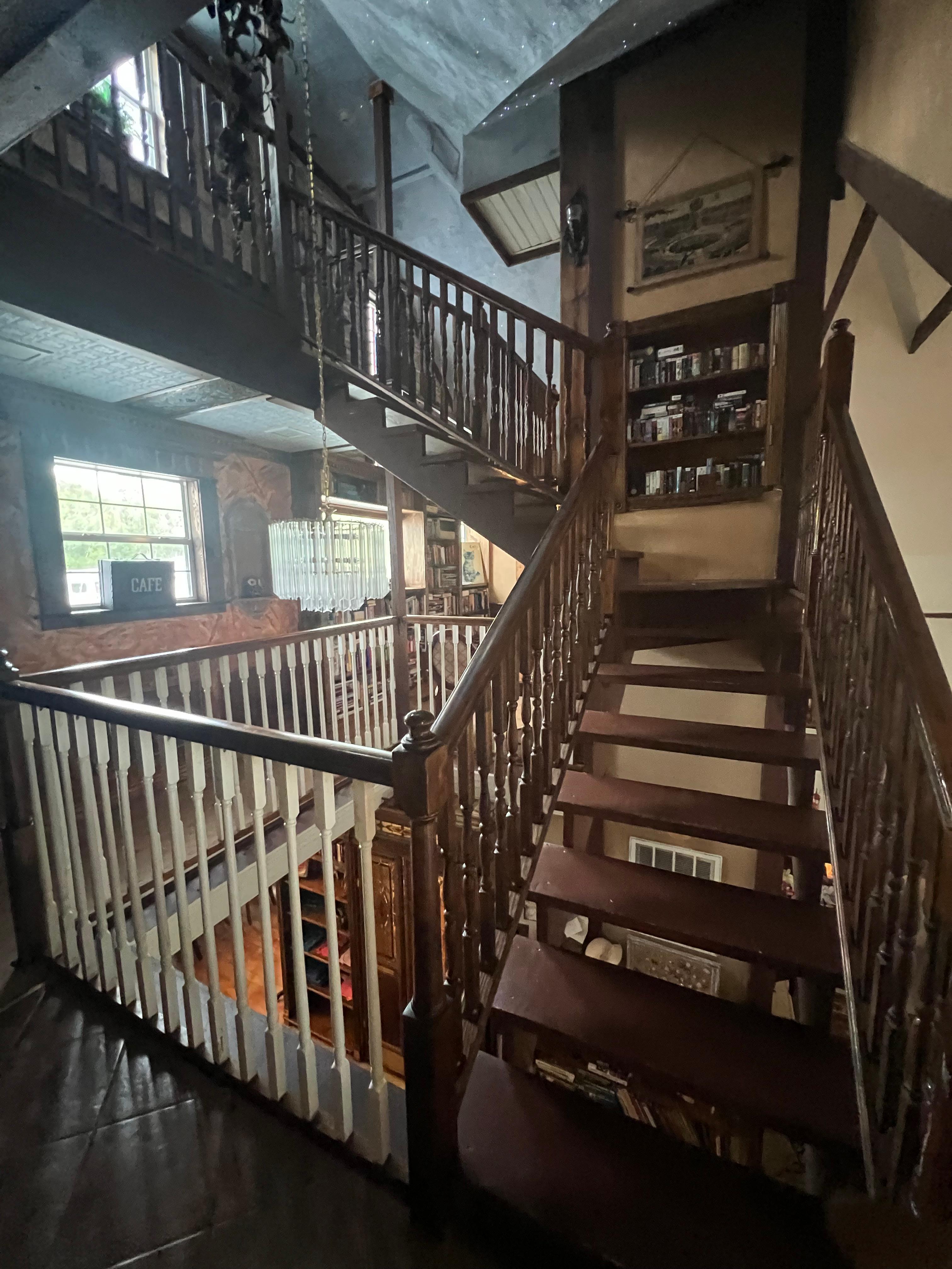 Stairs leading to bookcase with dvds