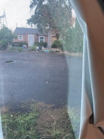 View of tenement next door, no lock on window.