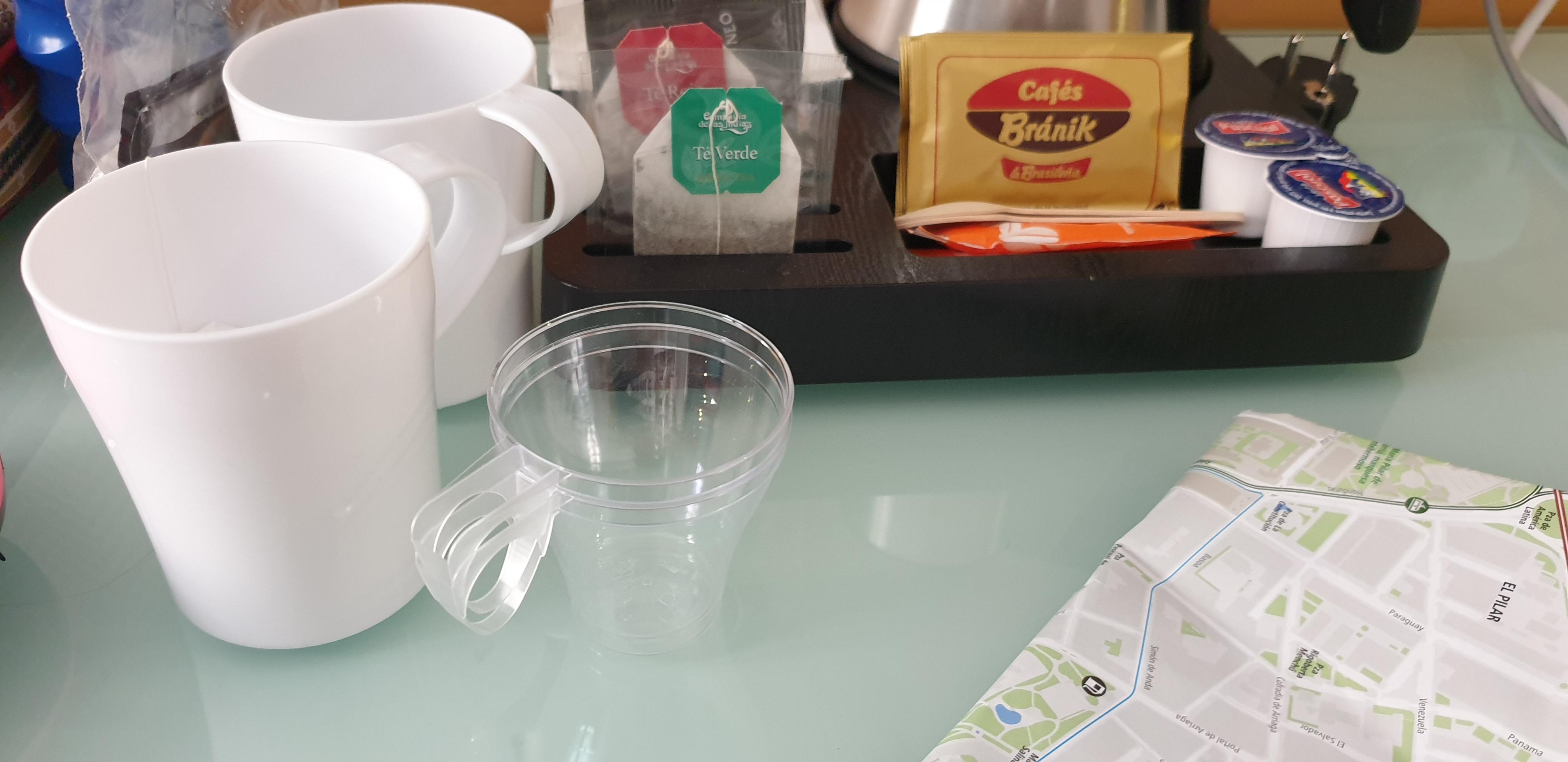 Clear tiny cups next to our own mugs.