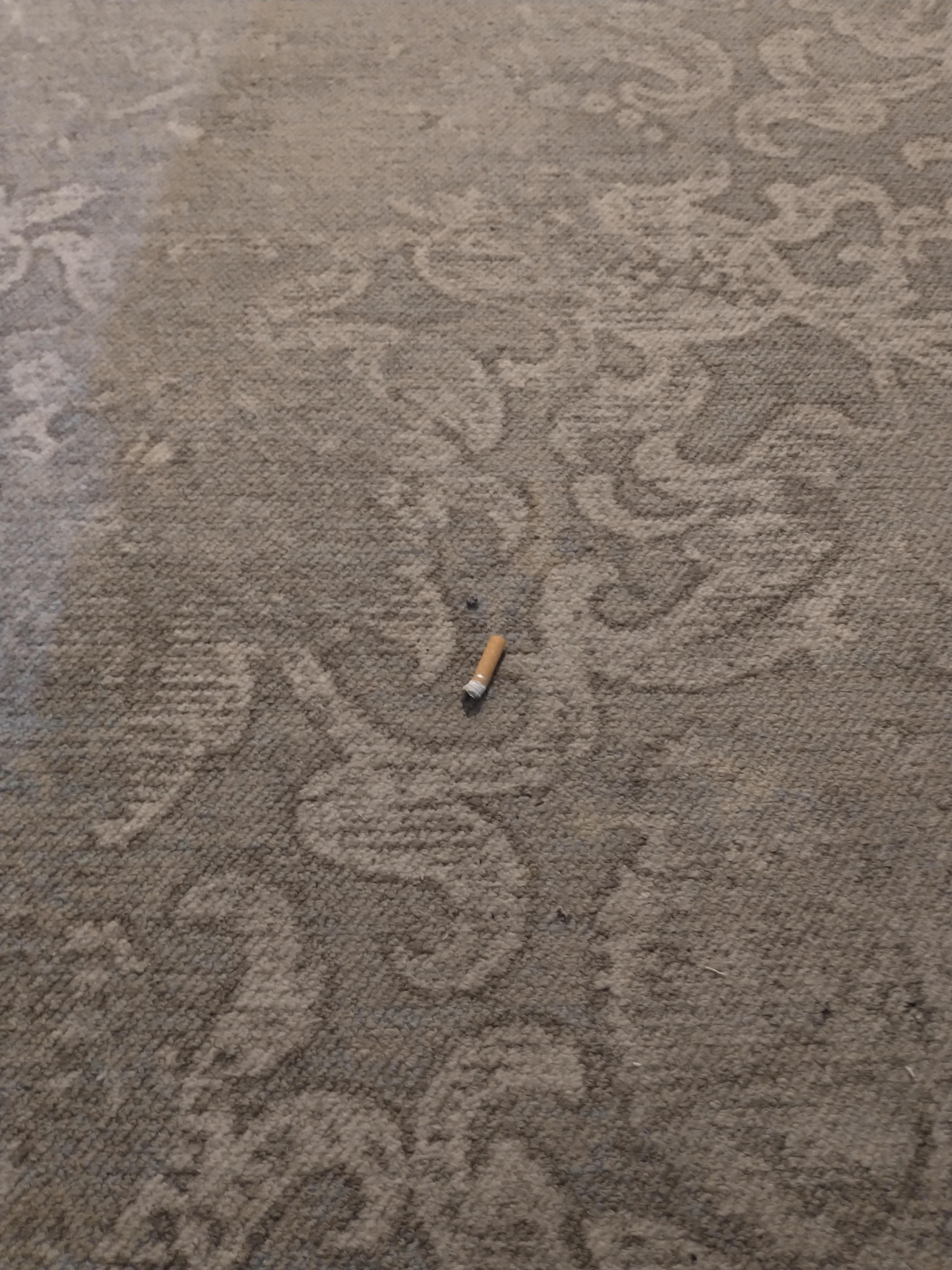 At the door to our room, we found a cigarette butt that had not been extinguished and left to burn a small hole into the dirty carpet.