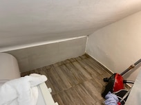 Laundry area below staircase so awkward and it looks like there was mold and/or water damage